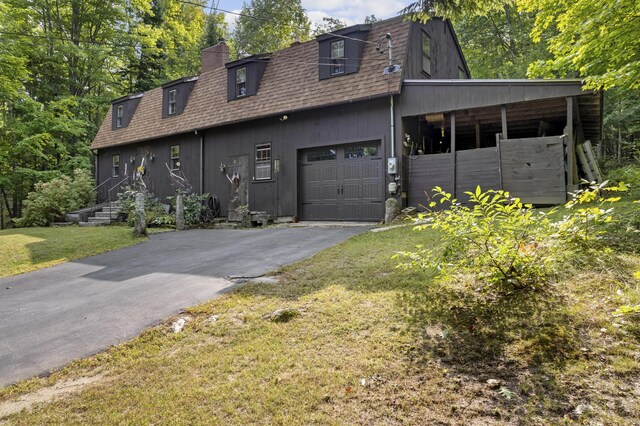 view of front of house with a front yard and a garage