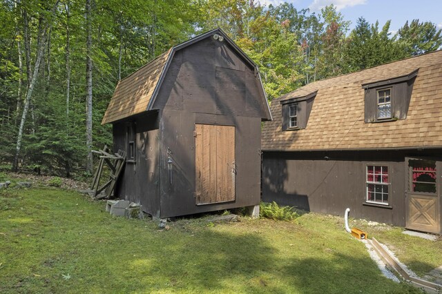 view of outbuilding featuring a lawn