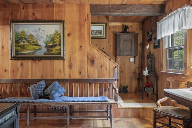 interior space featuring beamed ceiling, hardwood / wood-style floors, wood ceiling, and wood walls