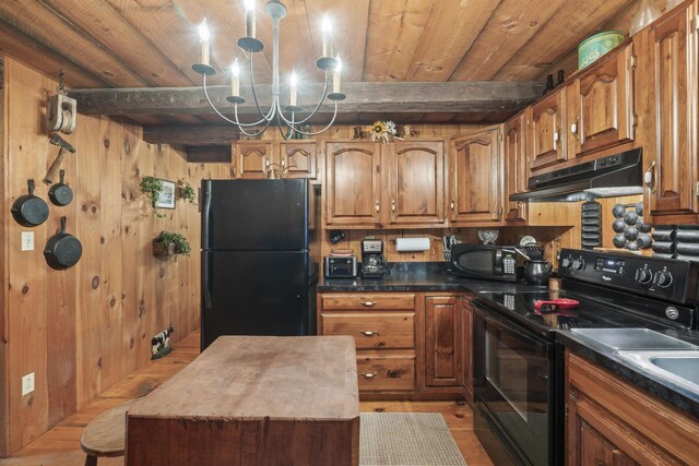 kitchen with black appliances, a chandelier, beam ceiling, and light hardwood / wood-style floors