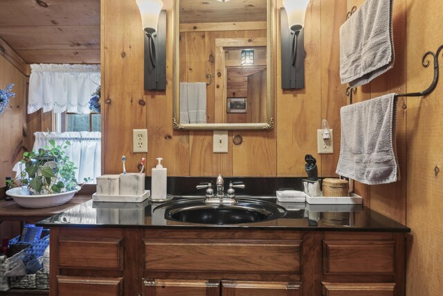 bathroom with sink, wooden walls, and wooden ceiling