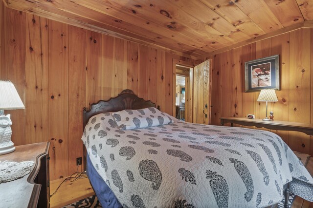 bedroom featuring wood ceiling and wood walls