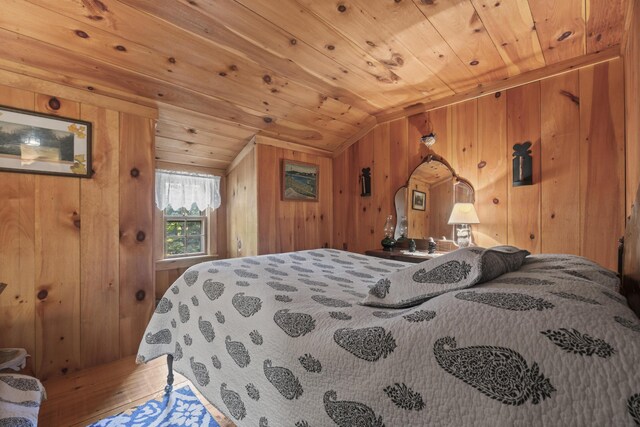 bedroom with vaulted ceiling, wooden walls, and wooden ceiling