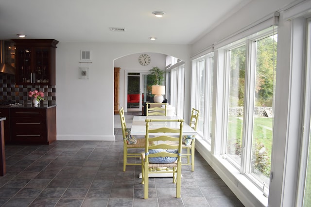 tiled dining space with a healthy amount of sunlight