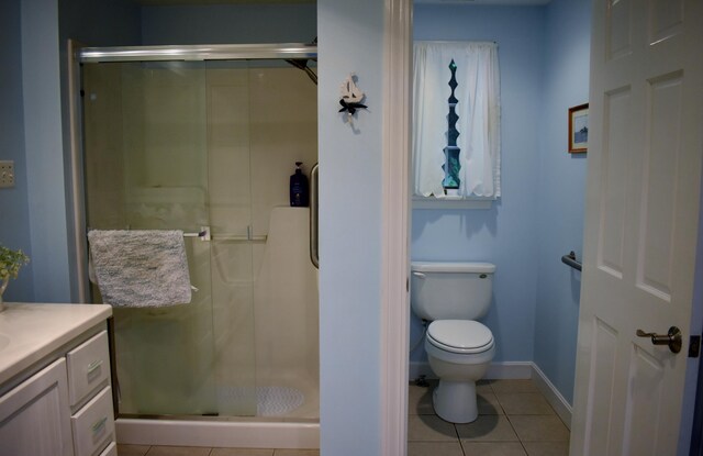 bathroom featuring vanity, tile patterned floors, an enclosed shower, and toilet