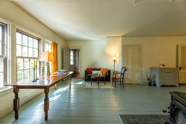 home office featuring a wood stove, light hardwood / wood-style floors, and crown molding