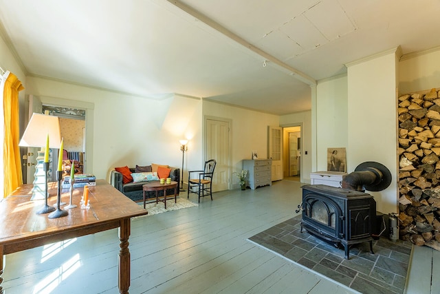 interior space with a wood stove, crown molding, and hardwood / wood-style floors