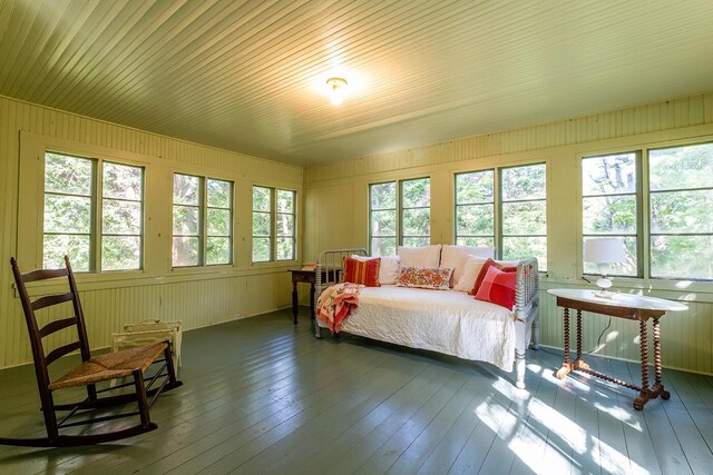 bedroom featuring wood ceiling, wood-type flooring, and wood walls