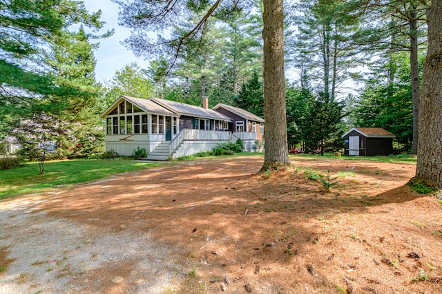 ranch-style home with a storage shed