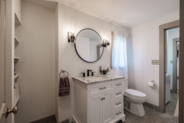 bathroom featuring vanity, toilet, and tile patterned flooring