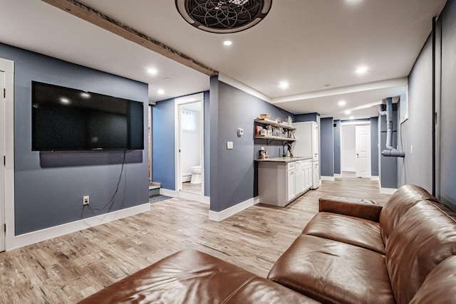 living room with light wood-type flooring and sink