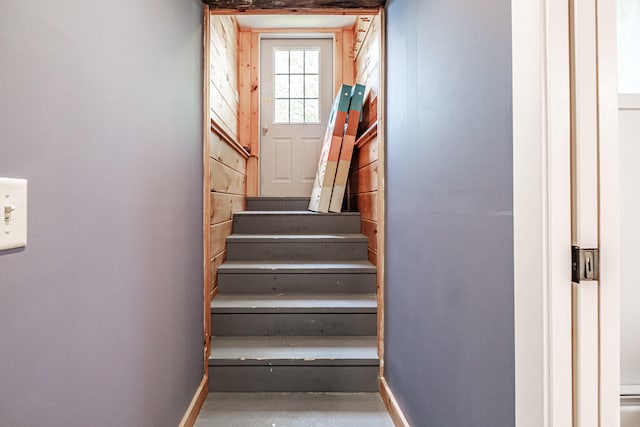 stairs with concrete flooring