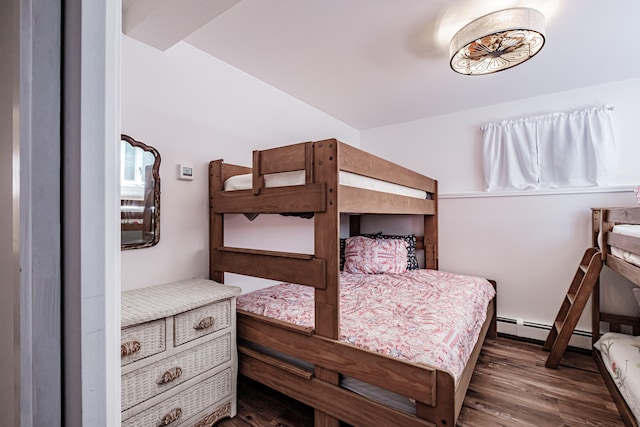 bedroom with a baseboard radiator and dark hardwood / wood-style floors