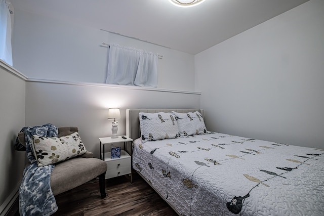 bedroom with dark hardwood / wood-style floors