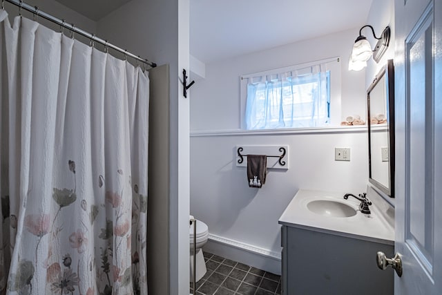 bathroom featuring vanity, toilet, tile patterned floors, and walk in shower