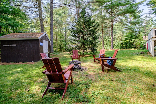 view of yard featuring a storage unit and an outdoor fire pit