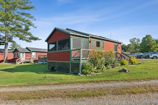 1270 Lakeview Dr Unit 23, China, ME 04358 - view of home's exterior featuring a wooden deck, a sunroom, and a yard