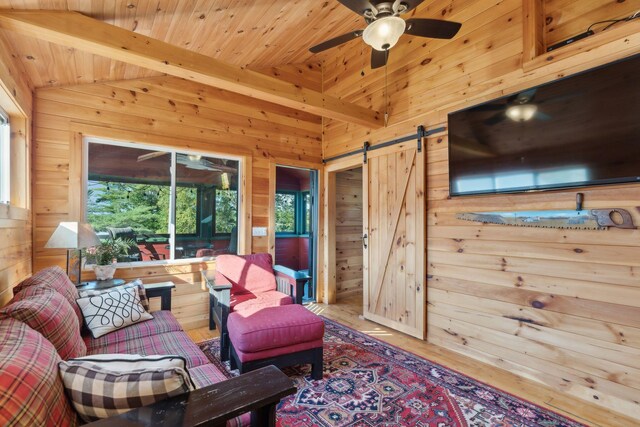 1270 Lakeview Dr Unit 23, China, ME 04358 - living area with a barn door, wooden walls, ceiling fan, wood finished floors, and wooden ceiling