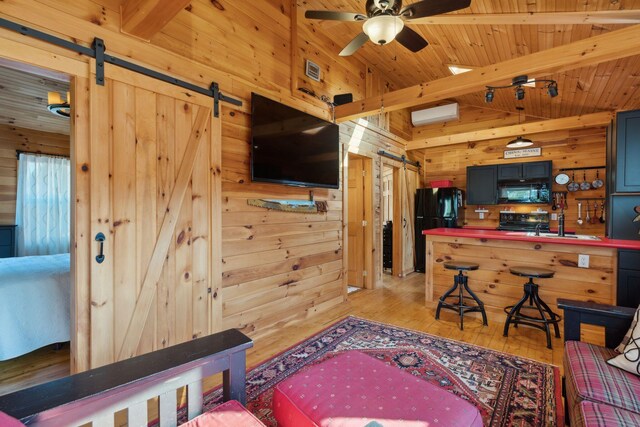 1270 Lakeview Dr Unit 23, China, ME 04358 - living area with a barn door, wooden walls, light wood finished floors, a ceiling fan, and wood ceiling with exposed beams