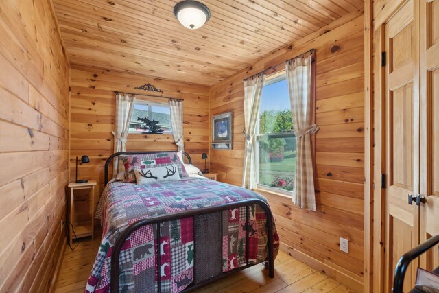 1270 Lakeview Dr Unit 23, China, ME 04358 - bedroom featuring multiple windows, wood-type flooring, wooden walls, and wooden ceiling
