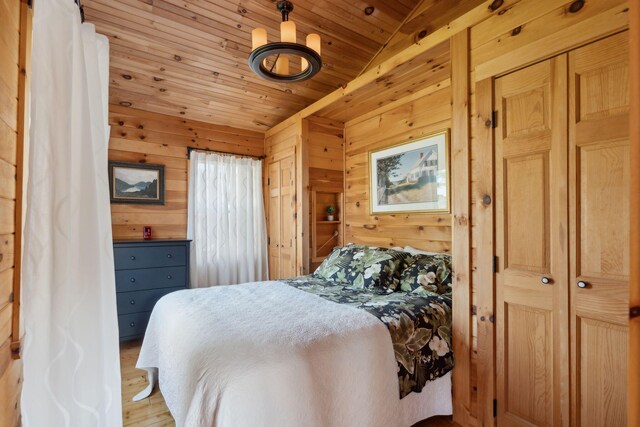 1270 Lakeview Dr Unit 23, China, ME 04358 - bedroom featuring wood walls, wood ceiling, and light wood-style floors