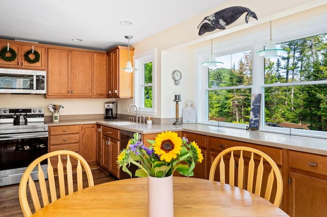 48 Camrock Dr, Rockport, ME 04856 - kitchen featuring stainless steel appliances, a sink, light countertops, decorative light fixtures, and brown cabinets