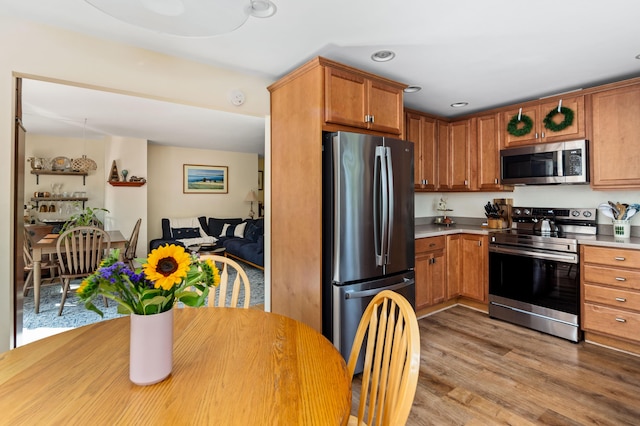 48 Camrock Dr, Rockport, ME 04856 - kitchen with appliances with stainless steel finishes, light countertops, wood finished floors, and brown cabinetry