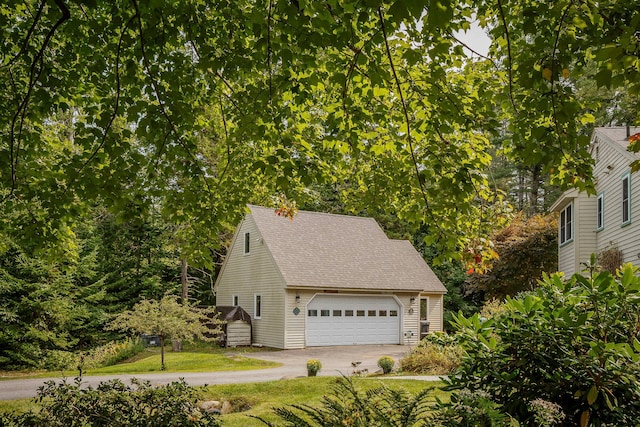 48 Camrock Dr, Rockport, ME 04856 - view of side of property with roof with shingles, a garage, and a lawn