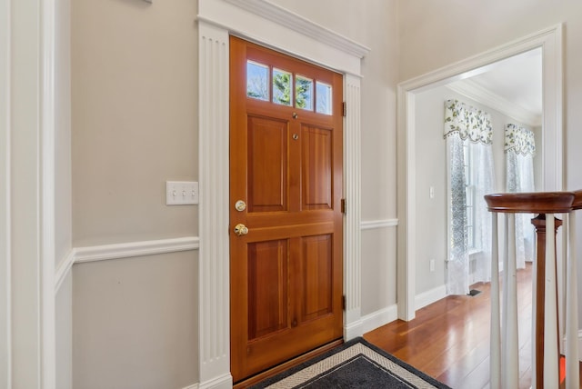 foyer entrance featuring baseboards and wood finished floors