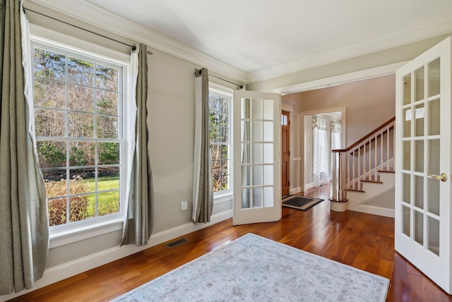 foyer featuring stairway, wood finished floors, visible vents, baseboards, and french doors