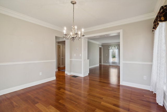 spare room with a notable chandelier, baseboards, and wood finished floors