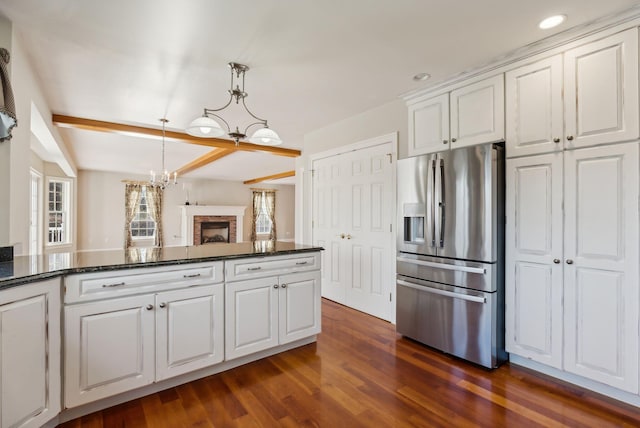 kitchen with white cabinetry, a notable chandelier, dark wood-style floors, and stainless steel refrigerator with ice dispenser