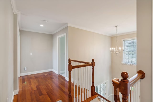 hallway with baseboards, an upstairs landing, dark wood finished floors, and ornamental molding