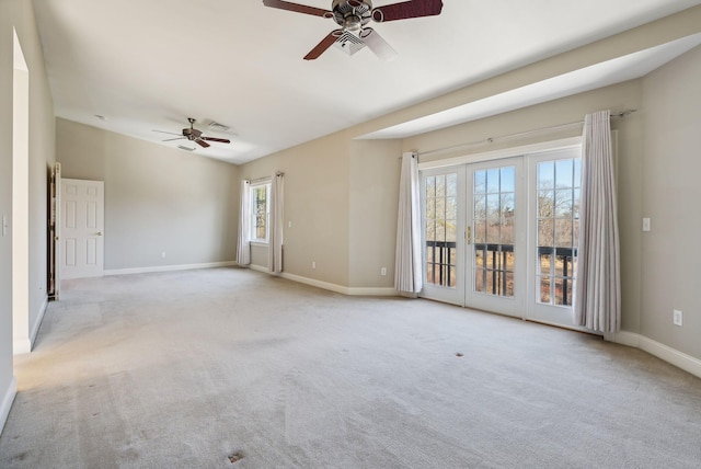 carpeted empty room with visible vents, baseboards, and ceiling fan