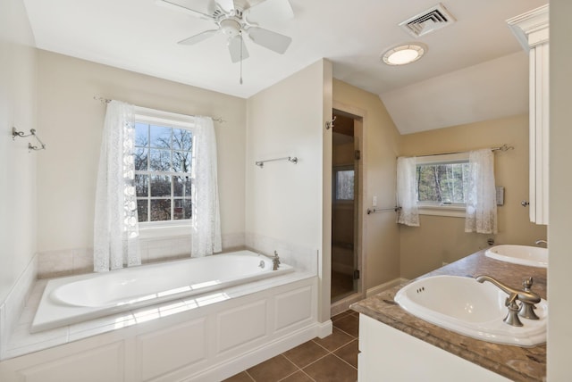 full bathroom featuring tile patterned floors, a garden tub, visible vents, and a sink