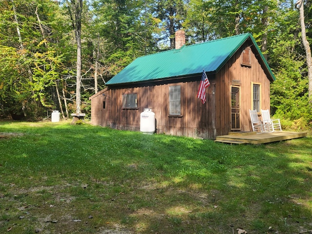 view of outbuilding with a yard