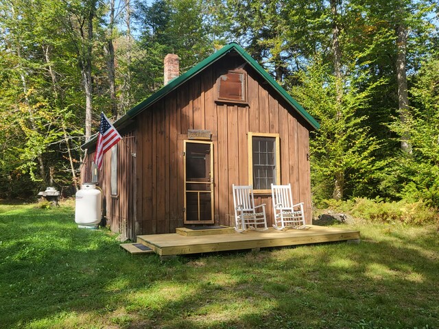 view of outbuilding featuring a lawn