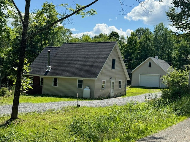 view of side of home with a garage and a lawn