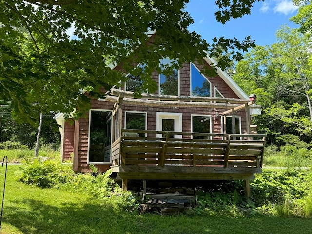 back of house with a lawn and a deck