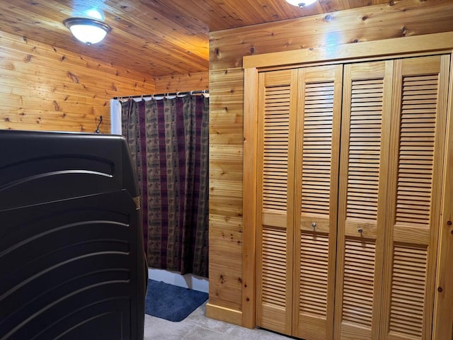 bathroom featuring wood ceiling and wooden walls