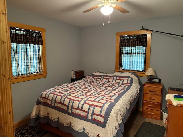 bedroom with ceiling fan and light tile patterned floors