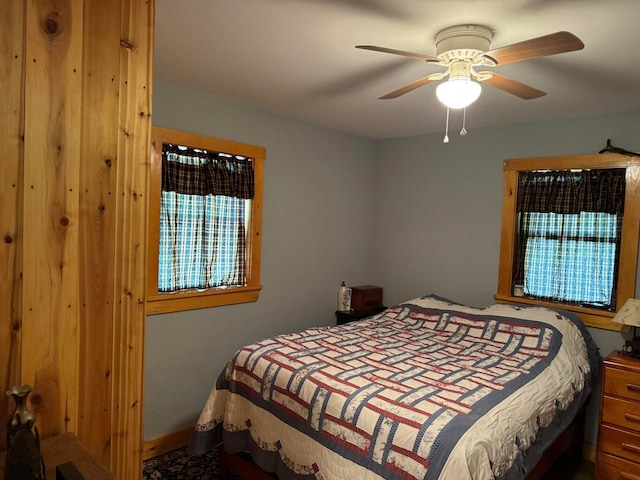 bedroom with ceiling fan and multiple windows