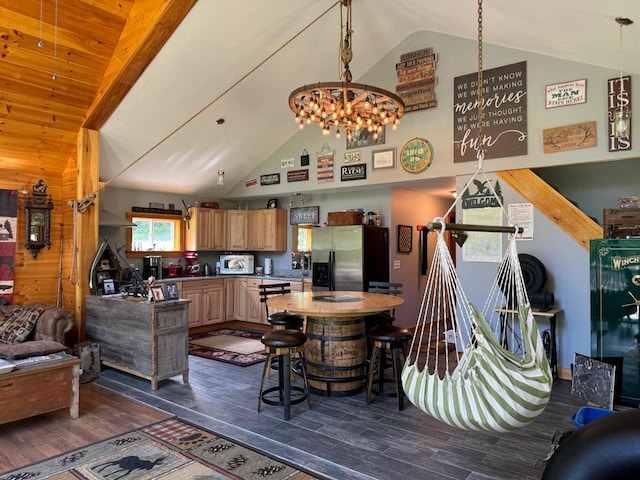 living room with wood walls, dark hardwood / wood-style floors, high vaulted ceiling, and a chandelier