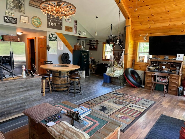 living room with high vaulted ceiling and hardwood / wood-style flooring