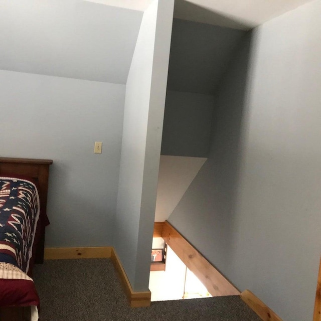 carpeted bedroom featuring lofted ceiling