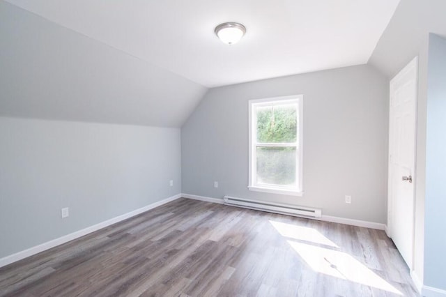 12 Sunset Ln, Otis, ME 04605 - additional living space with a baseboard heating unit, lofted ceiling, and wood finished floors