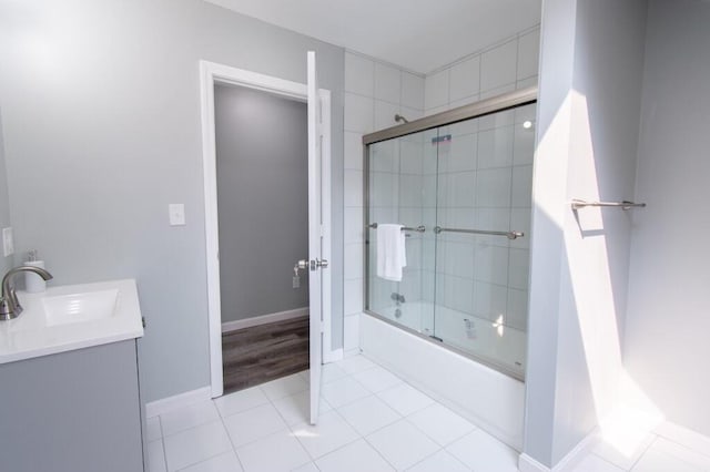 12 Sunset Ln, Otis, ME 04605 - full bathroom featuring tile patterned flooring, vanity, baseboards, and bath / shower combo with glass door