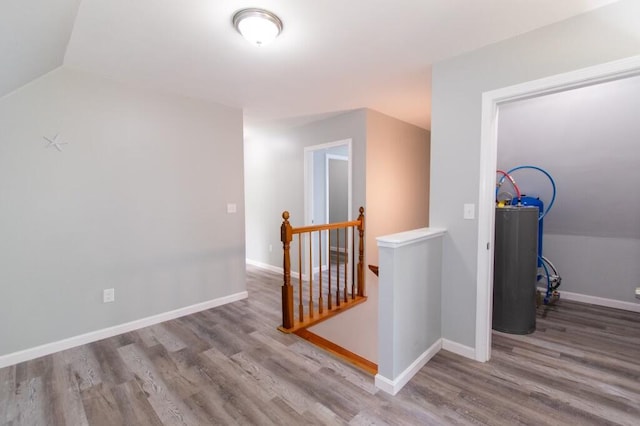12 Sunset Ln, Otis, ME 04605 - corridor featuring baseboards, an upstairs landing, wood finished floors, and water heater