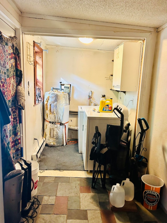 laundry room with a textured ceiling and washing machine and dryer