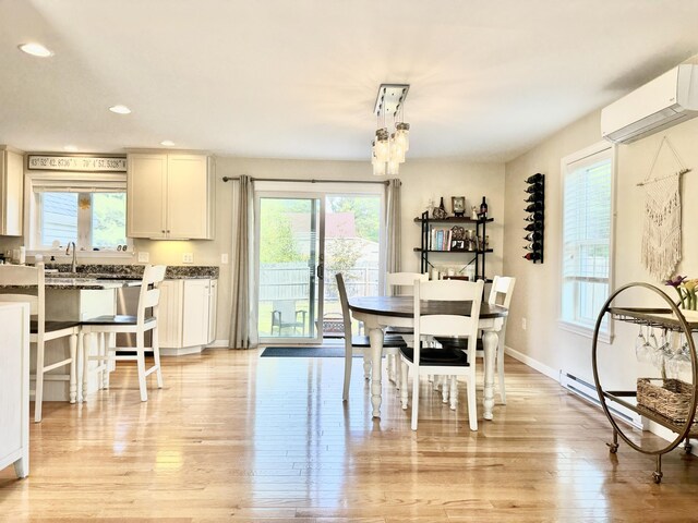 dining room with a healthy amount of sunlight and an AC wall unit